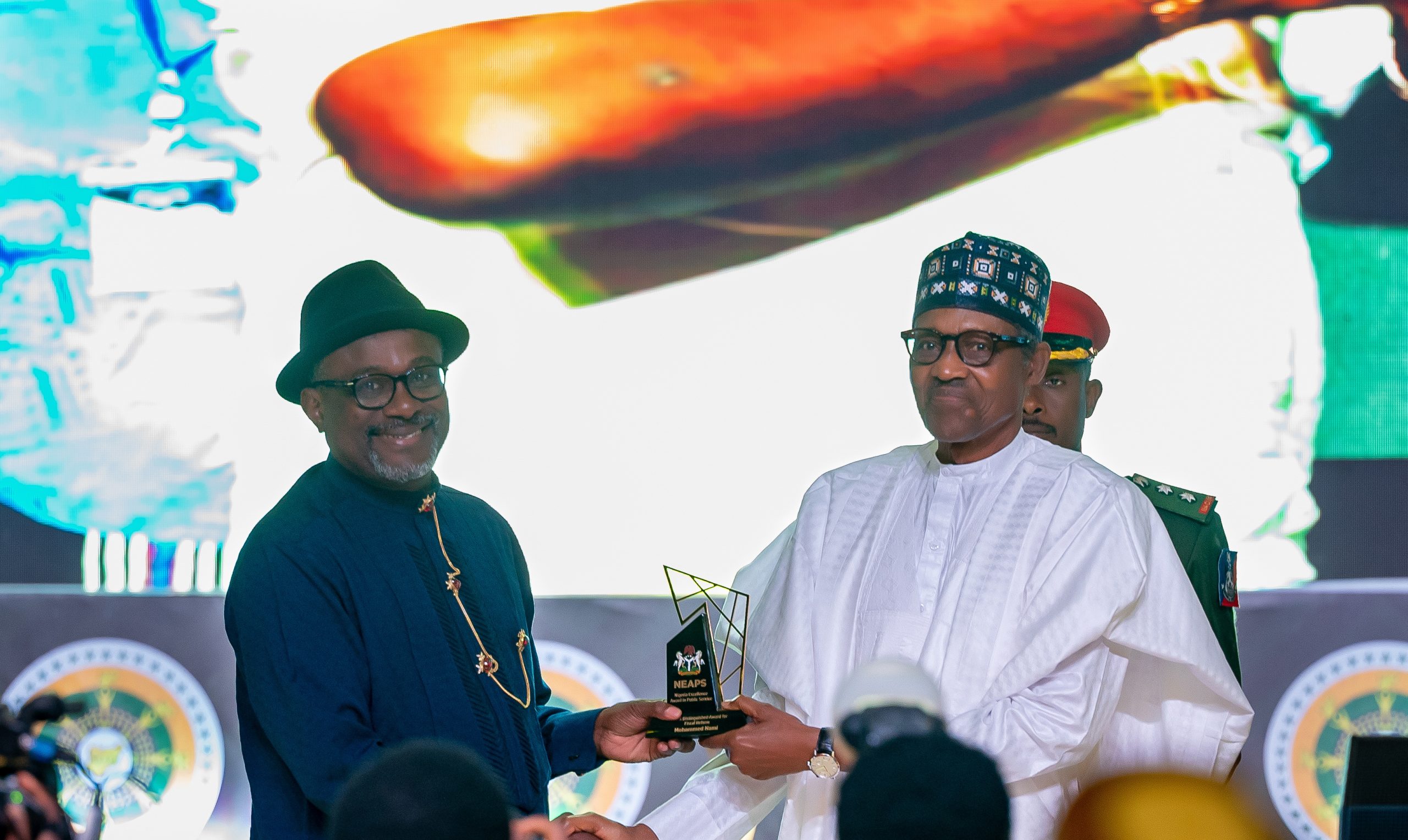 HE Presdient Muhammadu Buhari presenting the award for Capacity Development the Executive Secretary, National Content Development and Monitoring, Wabote Simbi