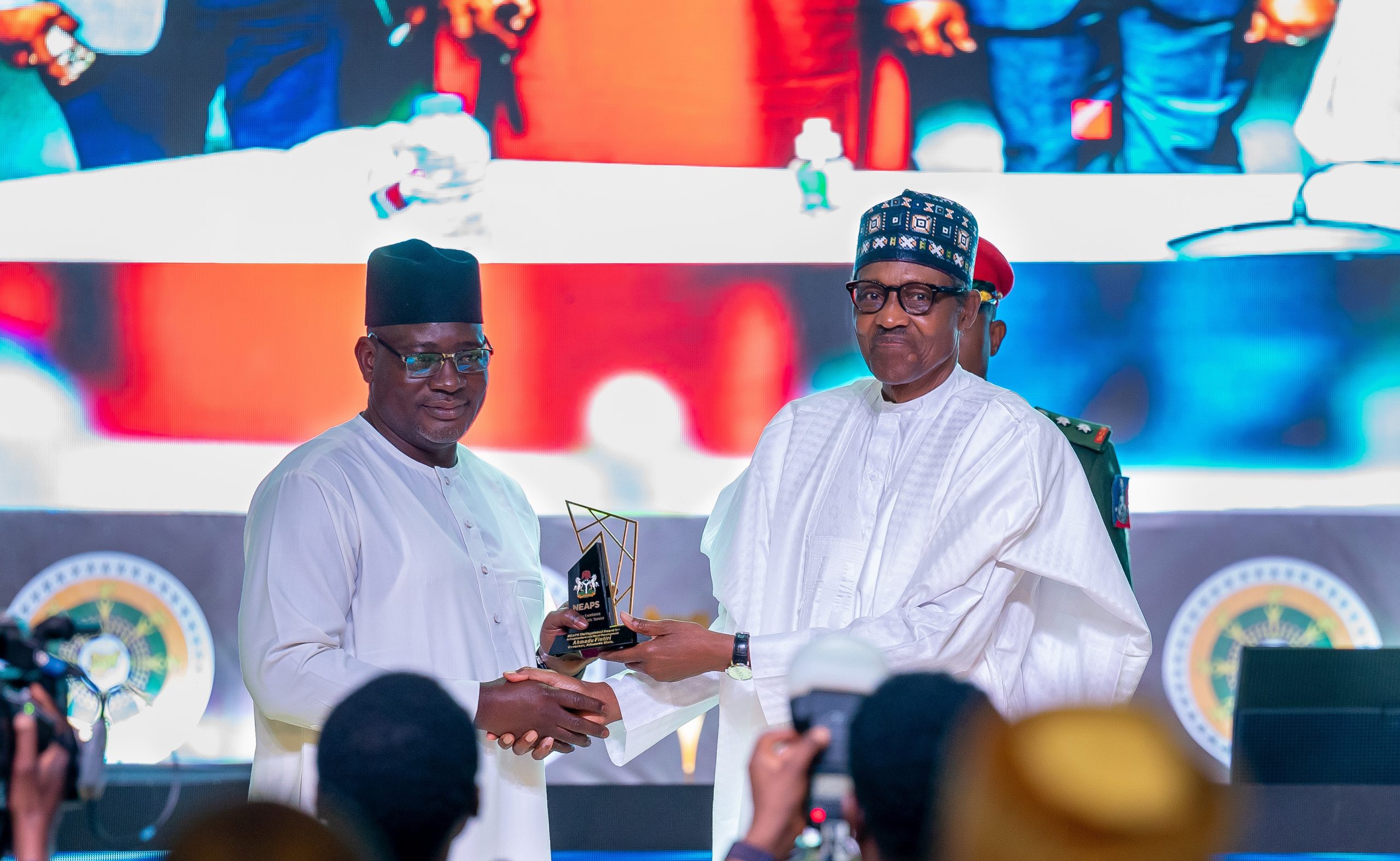 HE Presdient Muhammadu Buhari presenting the award for Fiscal Reform to the immediate Chairman of the FIRS, Nami Mohammed